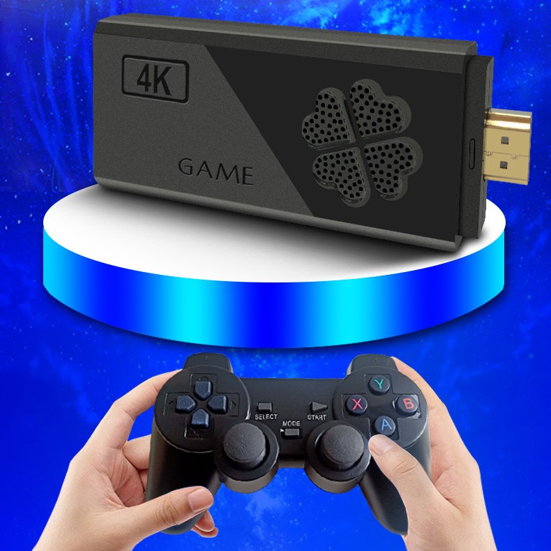 Black gaming console with '4K' and 'GAME' text, held by hands with a gaming controller against a blue gradient background.